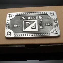 A metal plaque sitting on top of a box.