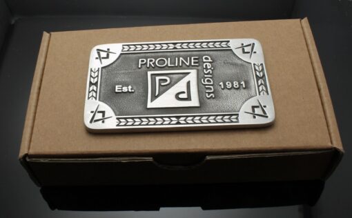 A metal plaque sitting on top of a box.
