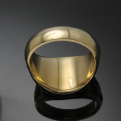 A gold ring is shown on the mirror.