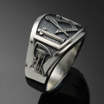 A silver ring with a masonic symbol on it.
