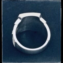 A silver ring with a black background