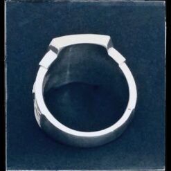 A silver ring with a black background