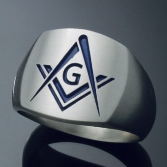 A silver ring with the letter g on it.